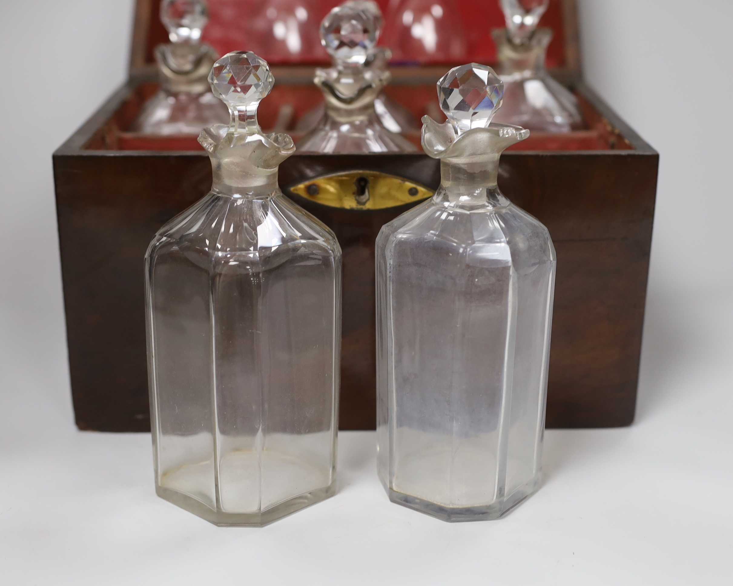 A decanter box with brass mount, possibly rosewood, six decanters and two glasses, 27cm wide